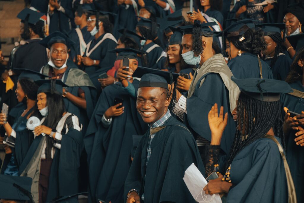 A group of happy graduates celebrating their achievements at a Nigerian university graduation ceremony.