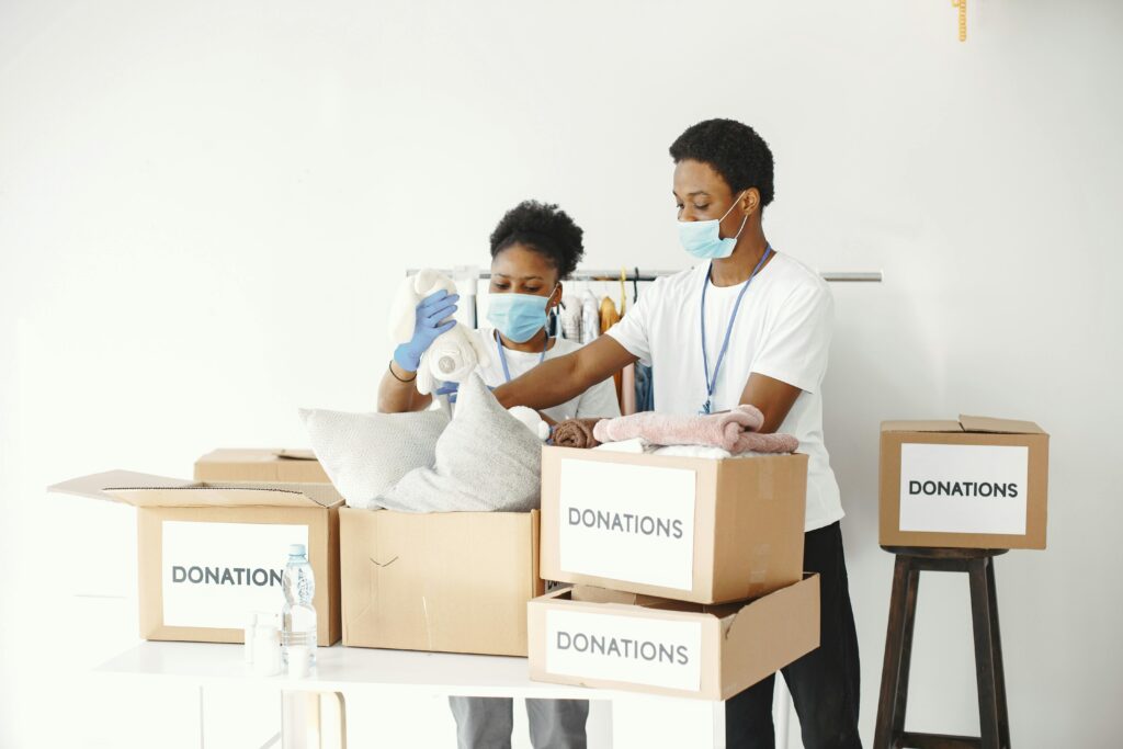 Group of volunteers packing donations for a charitable organization indoors.